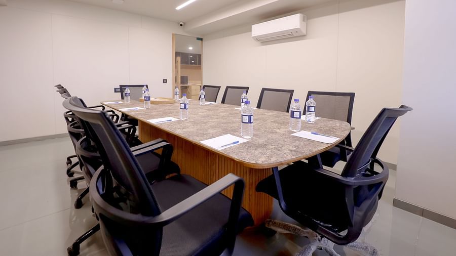 An image of a conference room with several chairs and a huge centre table - Pride Resort Ambaji